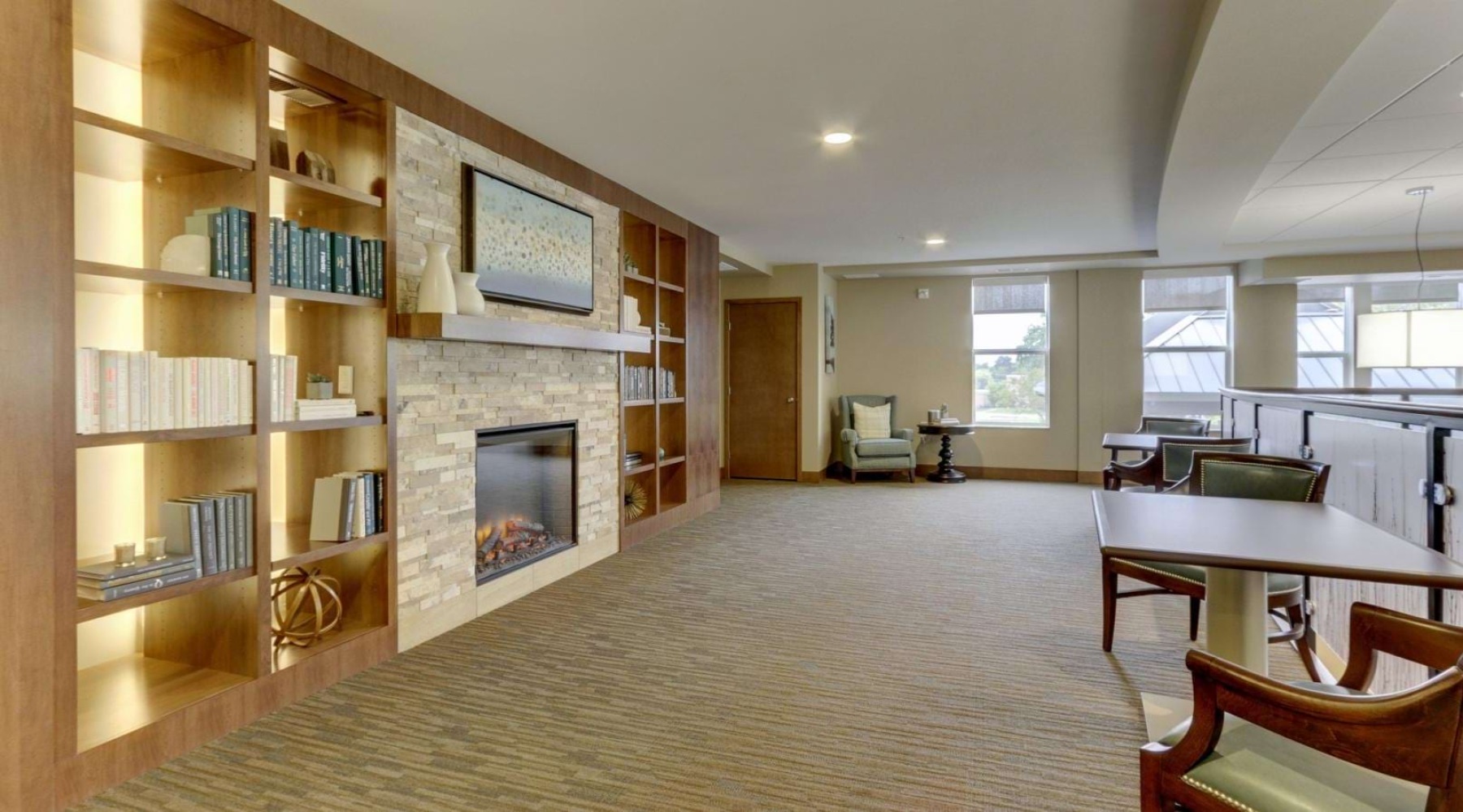 a room with a fireplace and bookshelves